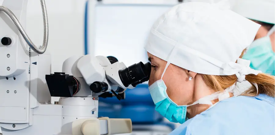 Ophthalmic surgeon looking through an operating microscope